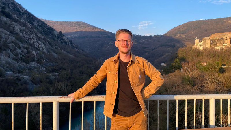 Student Melvin - a photo taken outdoors, on the bridge over the Soča river in Solkan
